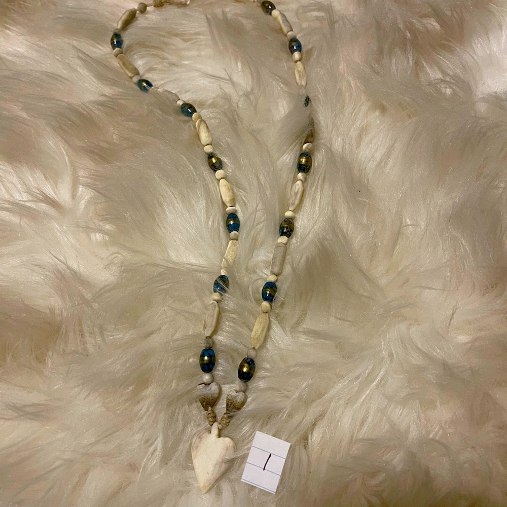 Hand crafted 14” necklace with a white heart pendant with blue beads
